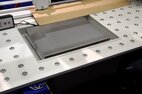 A cut-out for an integrated scale at a packing station. The desktop with ball roller system.